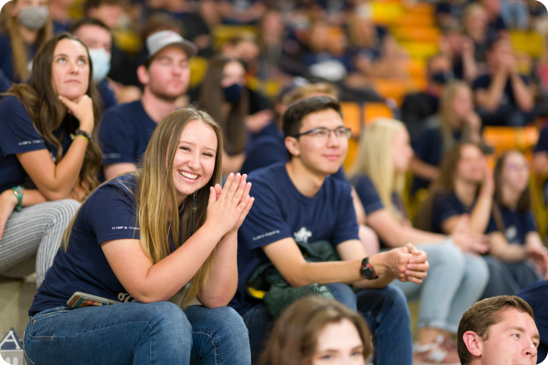 Utah State University students cheering in the stands