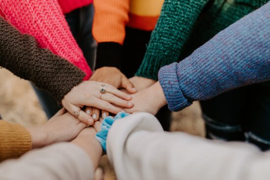 People with hands in a circle