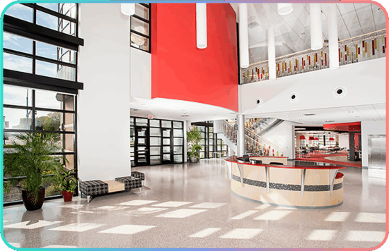 Bright student commons with a red accent wall at Grand View University