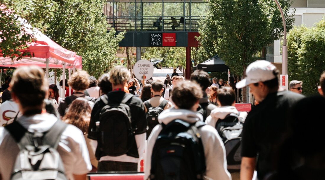 Students crossing a busy campus quad