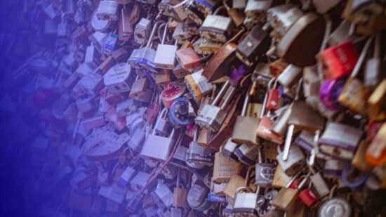 Wall of padlocks, tinted in Pathify purple — article: Cybersecurity and Consolidation